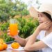 A Beautiful Woman Wearing A White T Shirt Holding A Glass Of Ora